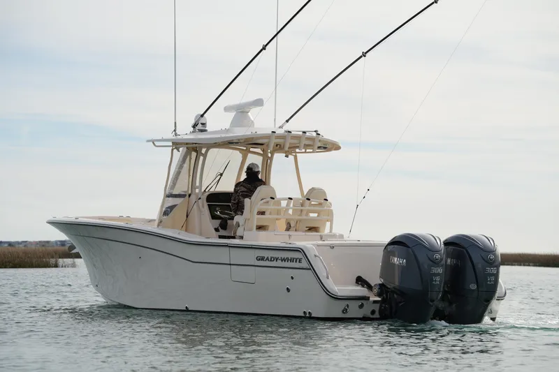 Slide: The Image of 2023 Grady-White Canyon 306 boat with dual Yamaha engines on water. - 11