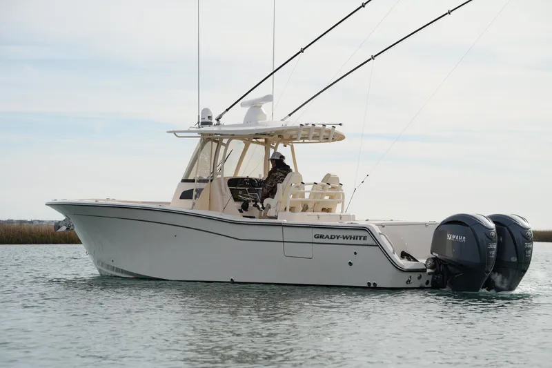Slide: The Image of 2023 Grady-White Canyon 306 boat on water with dual Yamaha engines. - 12