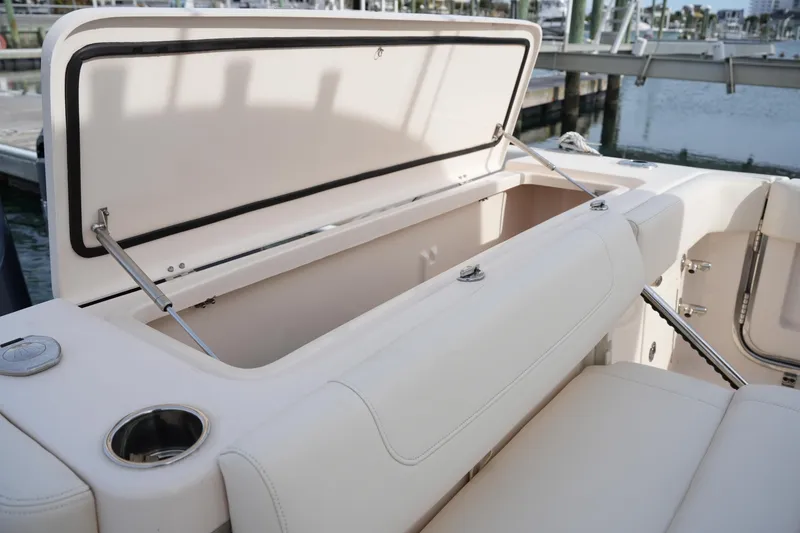 Slide: The Image of 2023 Grady-White Canyon 306 boat storage compartment open at marina. - 15