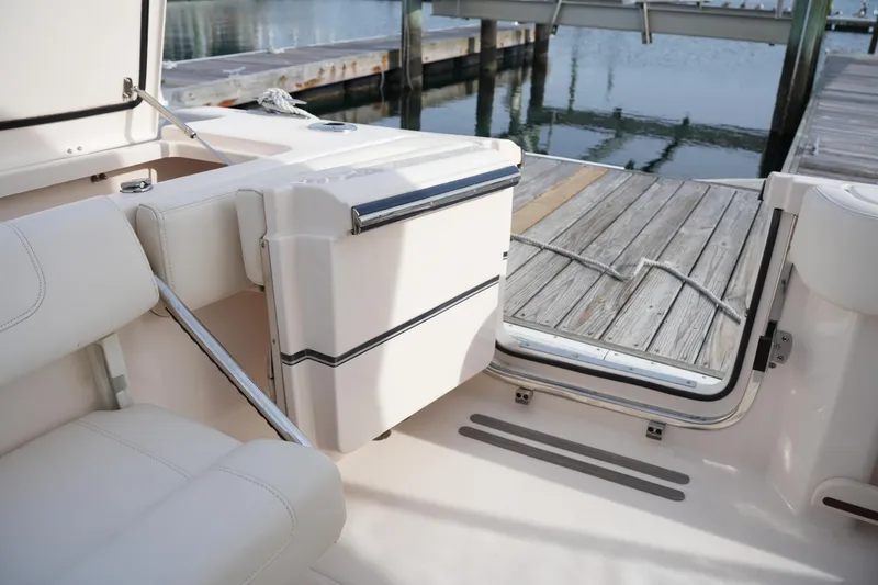 Slide: The Image of 2023 Grady-White Canyon 306 boat interior with open transom door at dock. - 18