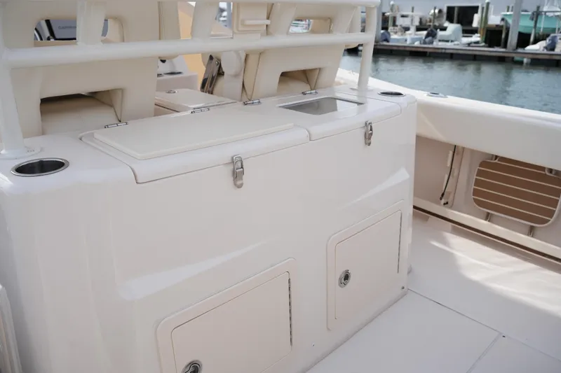 Slide: The Image of 2023 Grady-White Canyon 306 boat interior with storage compartments and seating. - 19