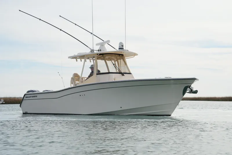 Slide: The Image of 2023 Grady-White Canyon 306 boat on calm water, side view. - 2