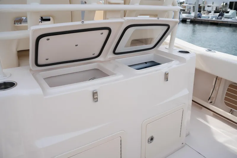 Slide: The Image of 2023 Grady-White Canyon 306 boat storage compartments open at marina. - 20
