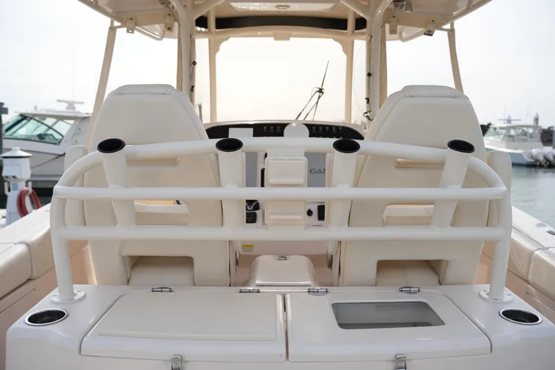 Slide: The Image of 2023 Grady-White Canyon 306 boat interior with seating and rod holders. - 21