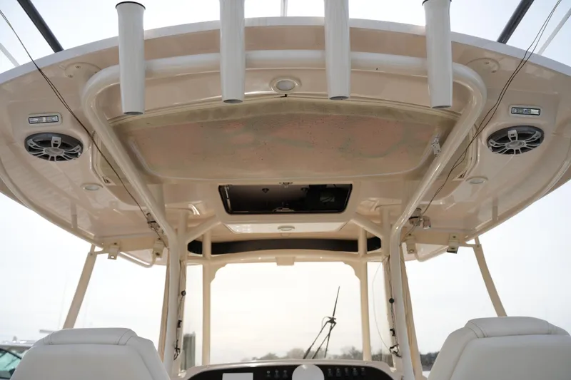 Slide: The Image of 2023 Grady-White Canyon 306 boat interior with rod holders and speakers. - 22