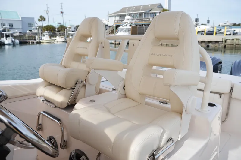 Slide: The Image of 2023 Grady-White Canyon 306 boat seats, luxurious design in marina setting. - 24