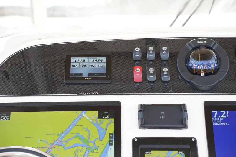 Slide: The Image of Dashboard of 2023 Grady-White Canyon 306 boat with navigation and control instruments. - 27