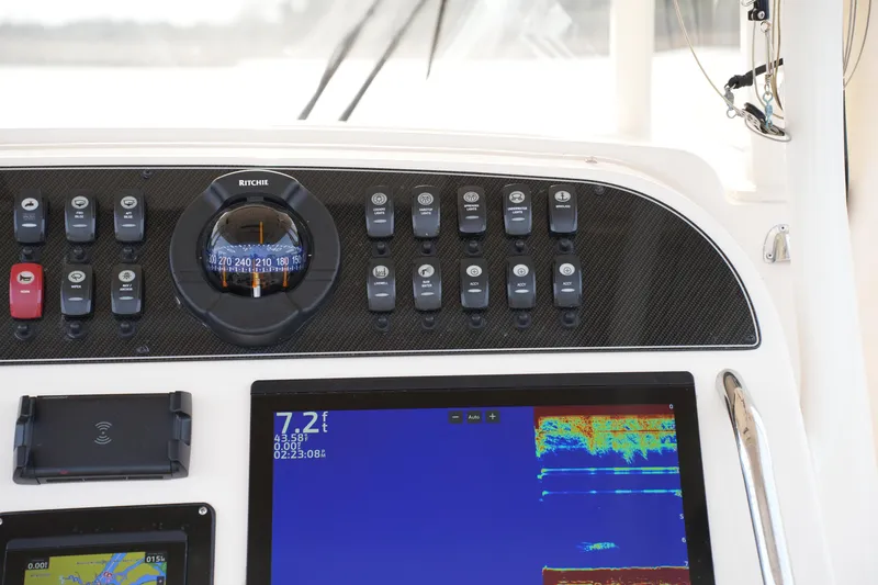 Slide: The Image of Dashboard of 2023 Grady-White Canyon 306 boat with navigation instruments and controls. - 28