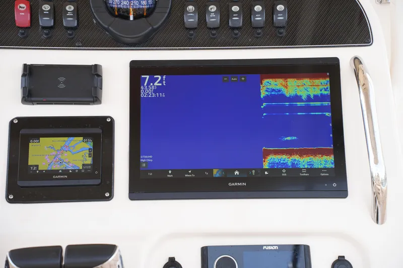 Slide: The Image of 2023 Grady-White Canyon 306 dashboard with Garmin navigation and sonar displays. - 29