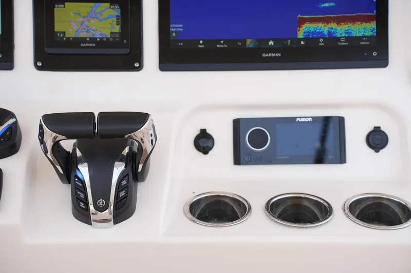 Slide: The Image of Control panel of 2023 Grady-White Canyon 306 boat with Garmin displays and Fusion audio system. - 30