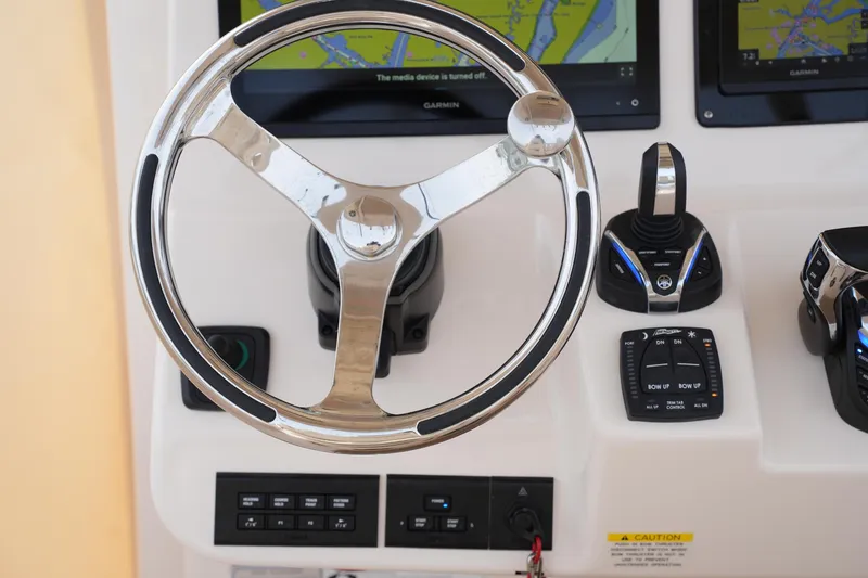 Slide: The Image of Steering console of 2023 Grady-White Canyon 306 boat with navigation controls. - 31