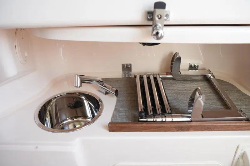 Slide: The Image of 2023 Grady-White Canyon 306 boat interior with sink and foldable ladder. - 36
