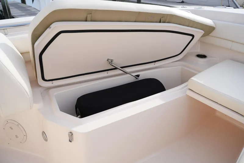 Slide: The Image of 2023 Grady-White Canyon 306 boat storage compartment with cushioned seating. - 39