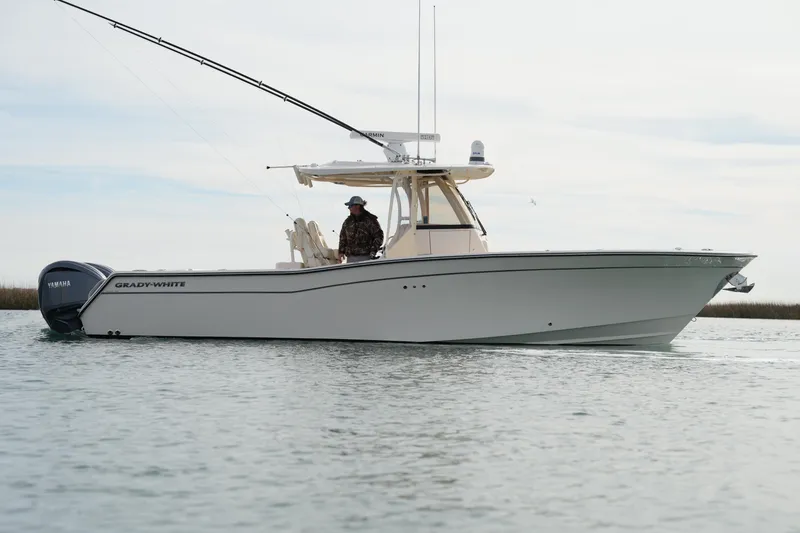 Slide: The Image of 2023 Grady-White Canyon 306 boat on calm water, side view. - 5