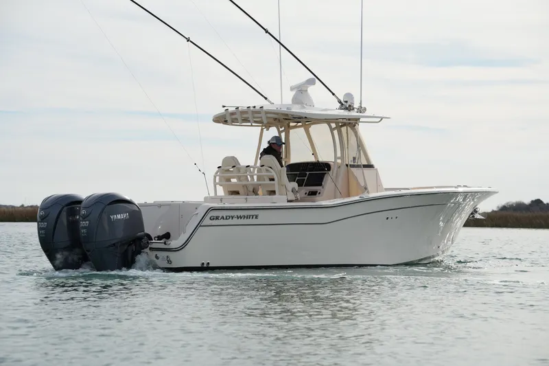 Slide: The Image of 2023 Grady-White Canyon 306 boat cruising with dual Yamaha engines. - 6