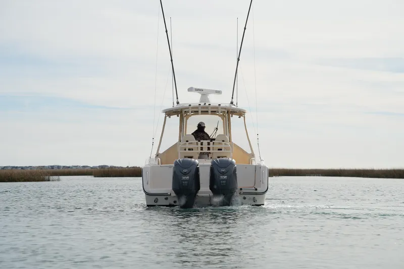 Slide: The Image of 2023 Grady-White Canyon 306 boat with dual engines on calm water. - 8