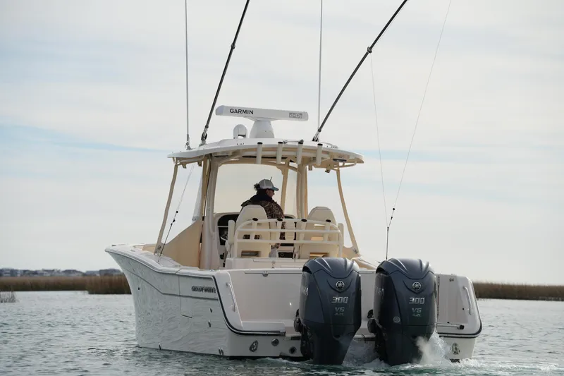 Slide: The Image of 2023 Grady-White Canyon 306 boat with dual Yamaha engines on water. - 9