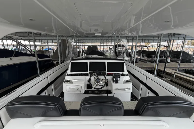 Slide: The Image of 2017 Cigarette 41' GTR boat interior with modern dashboard and seating in a marina. - 11