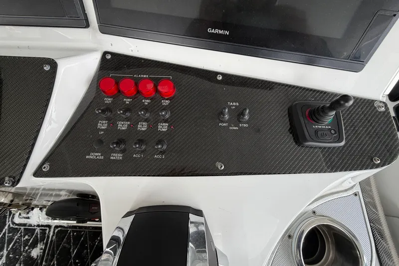 Slide: The Image of Control panel of a 2017 Cigarette 41' GTR boat with switches and joystick. - 12
