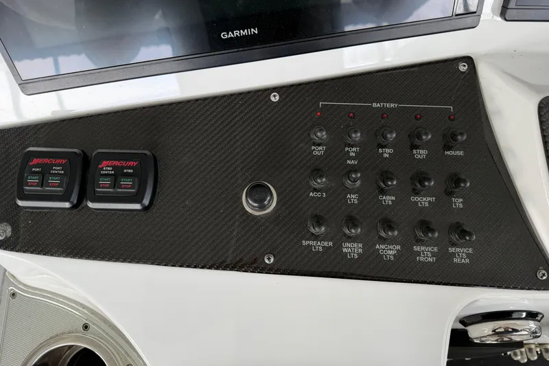 Slide: The Image of Control panel of a 2017 Cigarette 41' GTR boat with Mercury start-stop switches. - 13
