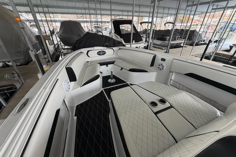 Slide: The Image of 2017 Cigarette 41' GTR boat interior with white seating and black accents in a marina. - 19