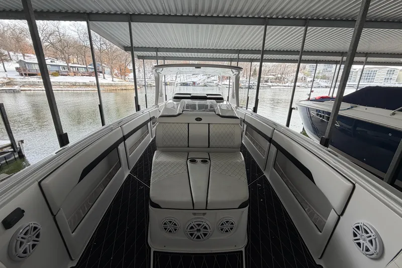 Slide: The Image of 2017 Cigarette 41' GTR boat docked under a covered marina with snowy surroundings. - 22
