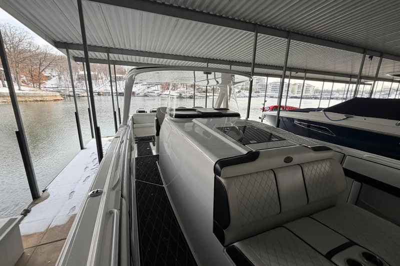 Slide: The Image of 2017 Cigarette 41' GTR boat docked under covered marina with scenic lake view. - 24