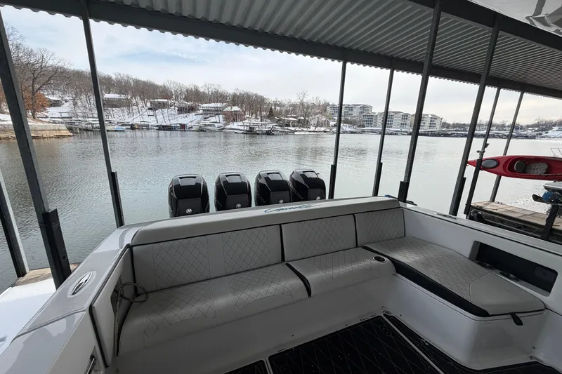 Slide: The Image of 2017 Cigarette 41' GTR boat with four engines docked by a snowy lakeside. - 25