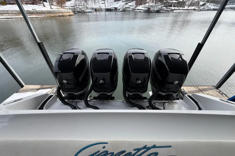 Slide: The Image of 2017 Cigarette 41' GTR boat with four powerful Mercury outboard engines on a calm lake. - 27