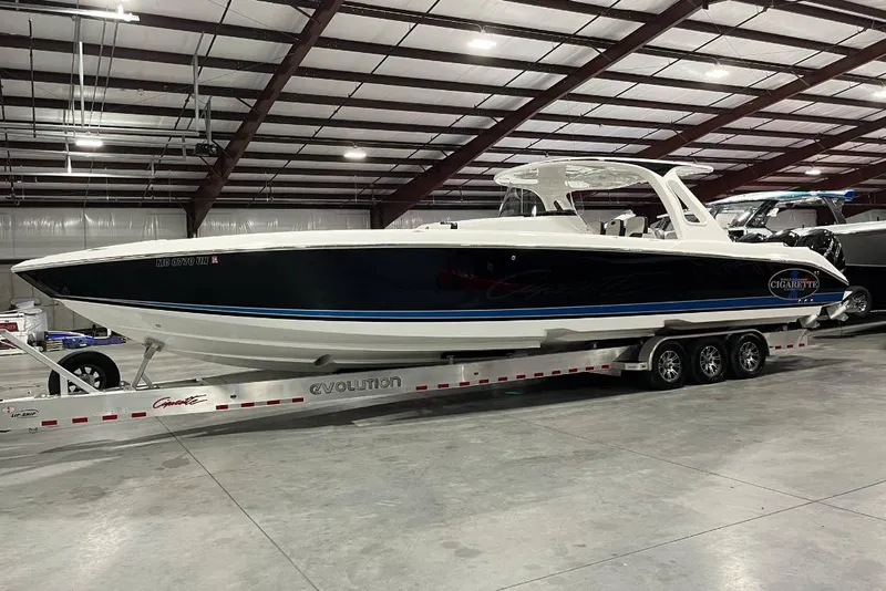 Slide: The Image of 2017 Cigarette 41' GTR boat cruising on a sunny lake near a dock. - 3