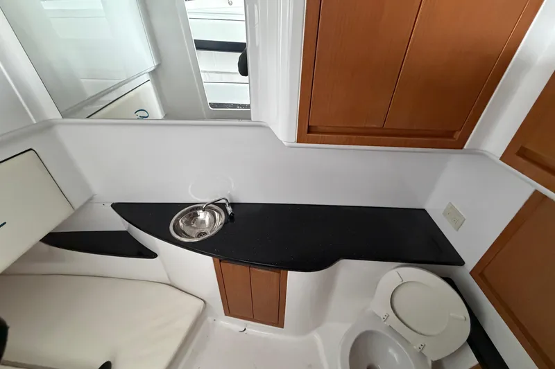 Slide: The Image of 2017 Cigarette 41' GTR boat interior with sink, toilet, and wooden cabinets. - 37