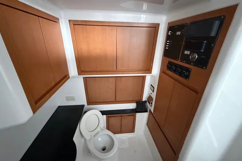 Slide: The Image of 2017 Cigarette 41' GTR boat bathroom with wooden cabinets and modern fixtures. - 38