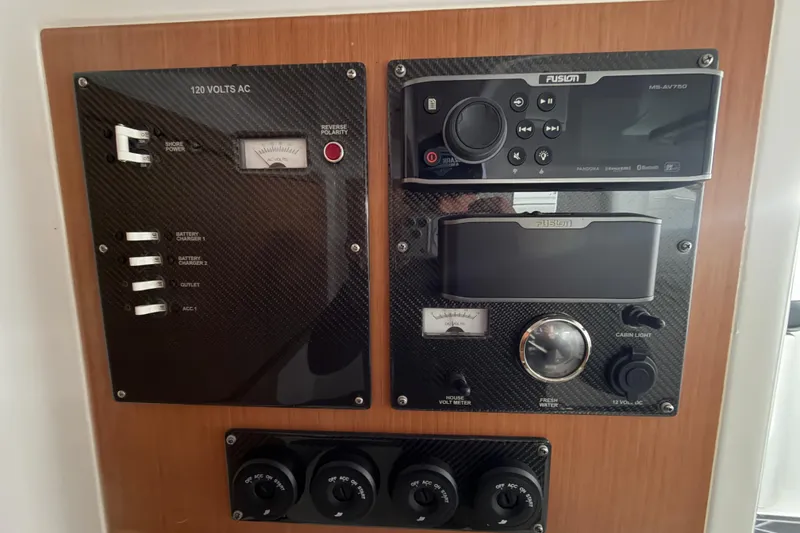 Slide: The Image of Control panel of a 2017 Cigarette 41' GTR boat with audio system and voltage meter. - 39