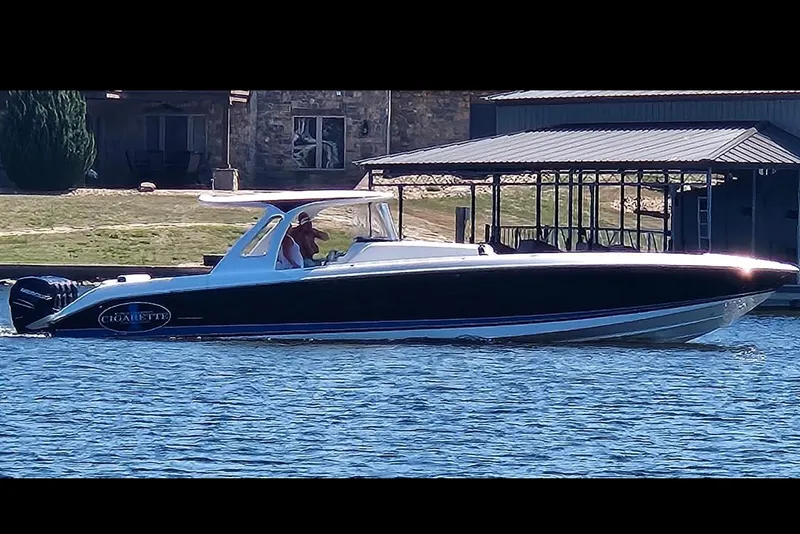 Slide: The Image of 2017 Cigarette 41' GTR speedboat cruising on a lake with waterfront homes in the background. - 4