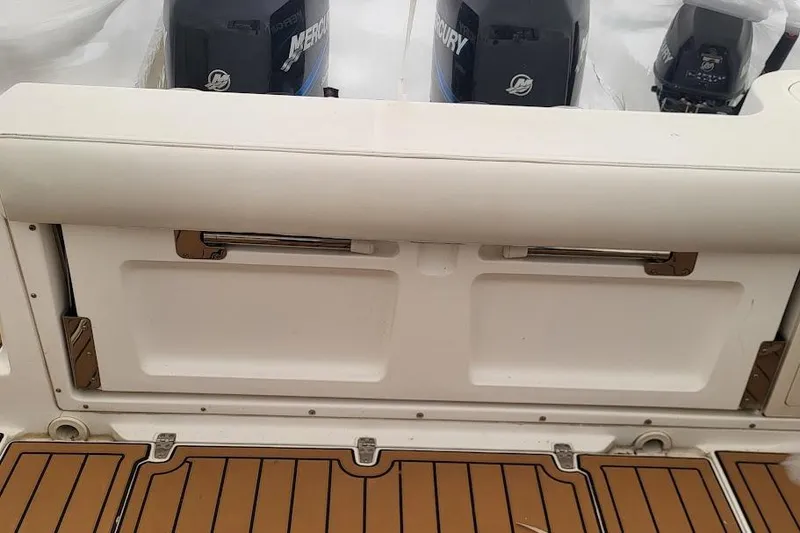 Slide: The Image of 2004 Boston Whaler 305 Conquest boat interior with Mercury engines visible. - 10