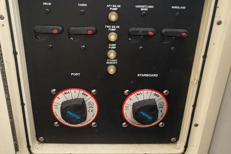 Slide: The Image of Control panel of a 2004 Boston Whaler 305 Conquest boat with switches and dials. - 12