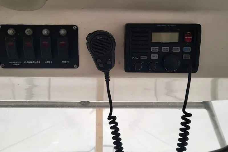 Slide: The Image of Control panel of a 2004 Boston Whaler 305 Conquest with radio and switches. - 13