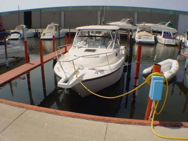 Slide: The Image of 2004 Boston Whaler 305 Conquest docked at marina. - 2