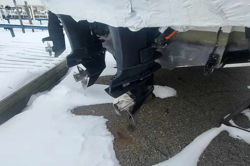 Slide: The Image of 2004 Boston Whaler 305 Conquest boat engines in snowy dock setting. - 4