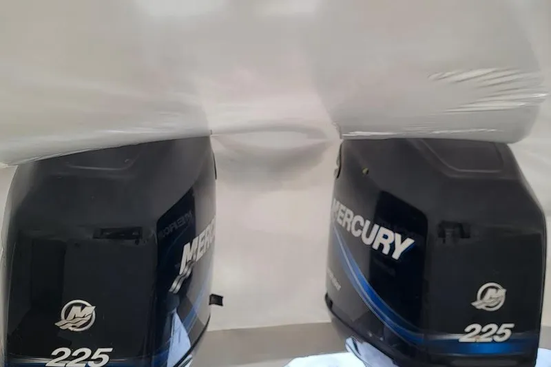 Slide: The Image of Twin Mercury 225 outboard engines on a 2004 Boston Whaler 305 Conquest boat. - 7