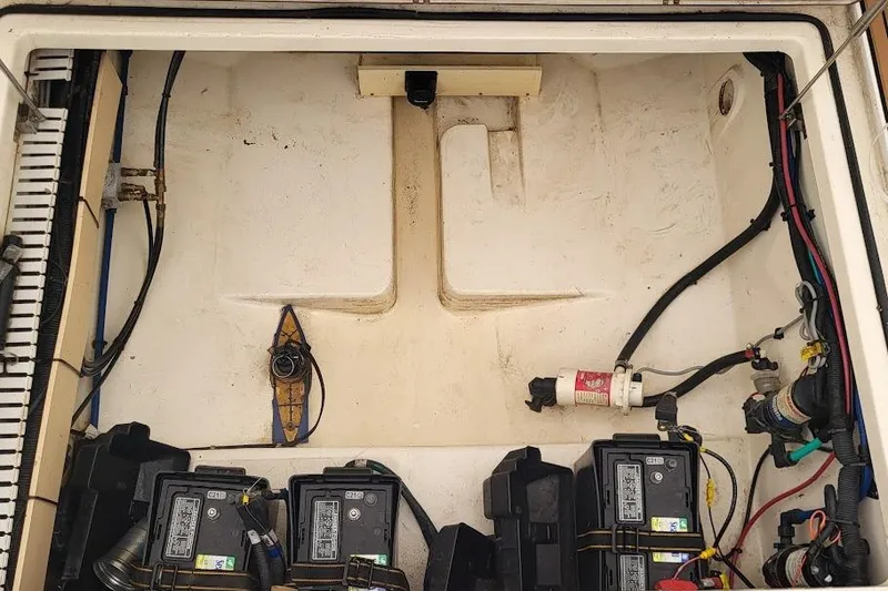 Slide: The Image of 2004 Boston Whaler 305 Conquest engine compartment with batteries and wiring. - 8