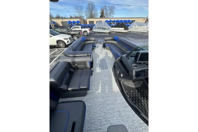 Slide: The Image of 2025 Bennington M Swingback 26 MSB pontoon boat interior with luxurious seating and modern dashboard. - 13