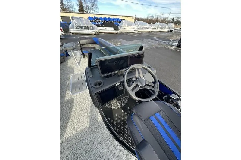 Slide: The Image of 2025 Bennington M Swingback 26 MSB boat dashboard with steering wheel and digital displays. - 17