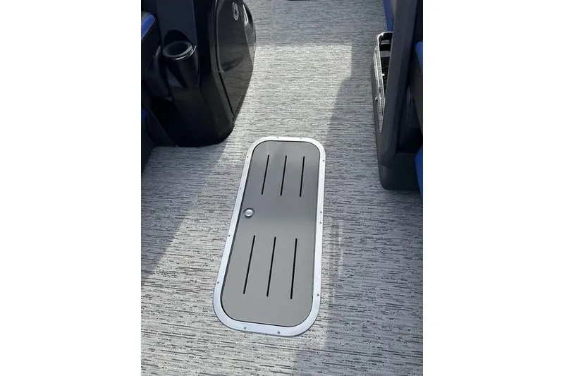 Slide: The Image of 2025 Bennington M Swingback 26 MSB boat interior with sleek flooring and storage hatch. - 18