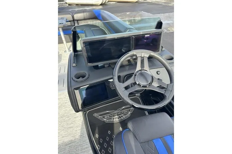 Slide: The Image of 2025 Bennington M Swingback 26 MSB dashboard with steering wheel and digital displays. - 22
