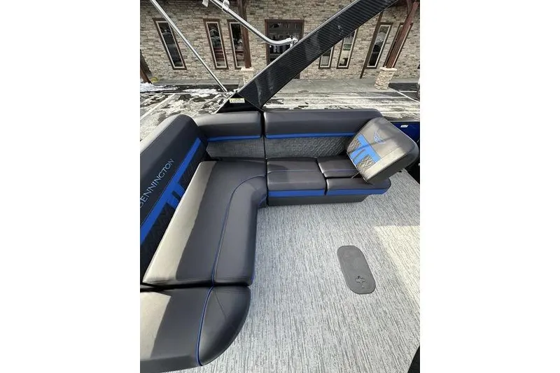 Slide: The Image of 2025 Bennington M Swingback 26 MSB boat interior with sleek black and blue seating. - 23