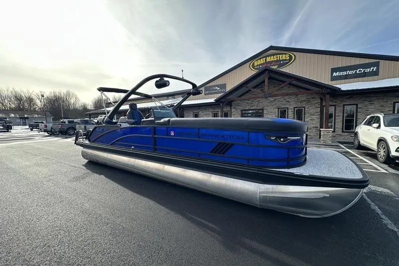 Slide: The Image of 2025 Bennington M Swingback 26 MSB pontoon boat parked outside dealership. - 3