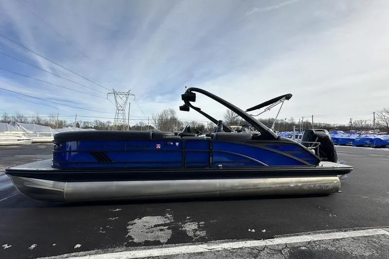 Slide: The Image of 2025 Bennington M Swingback 26 MSB pontoon boat in a parking lot. - 4
