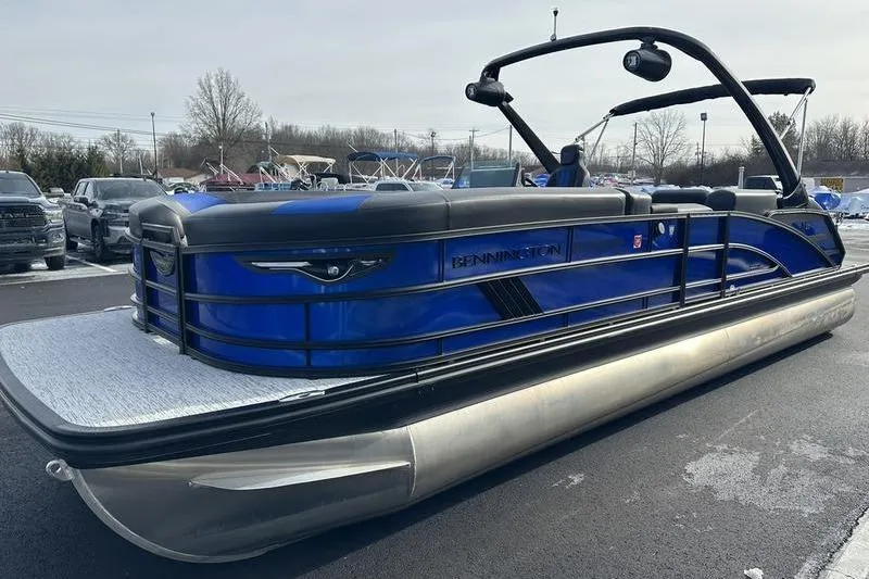 Slide: The Image of 2025 Bennington M Swingback 26 MSB pontoon boat in a parking lot. - 7
