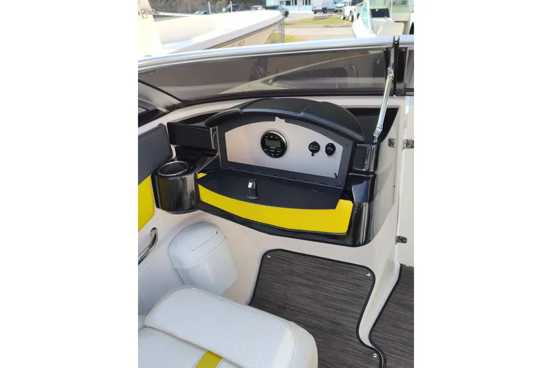 Slide: The Image of 2017 Four Winns 200 Horizon LE boat dashboard with yellow accents and modern controls. - 11